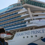 Uninfected passengers disembark from virus-hit ship in Japan