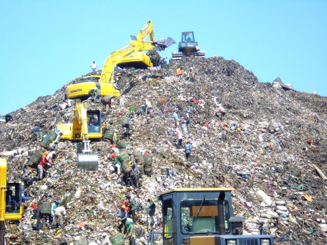 Rescue teams dig through garbage after a section of the Bantar Gebang landfill gave way during torrential rain.