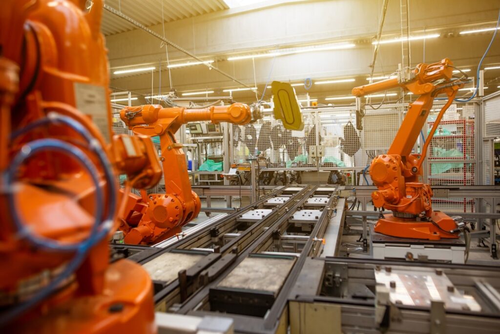 Workers in protective masks assemble car parts on a factory line in Hubei province during lockdown.