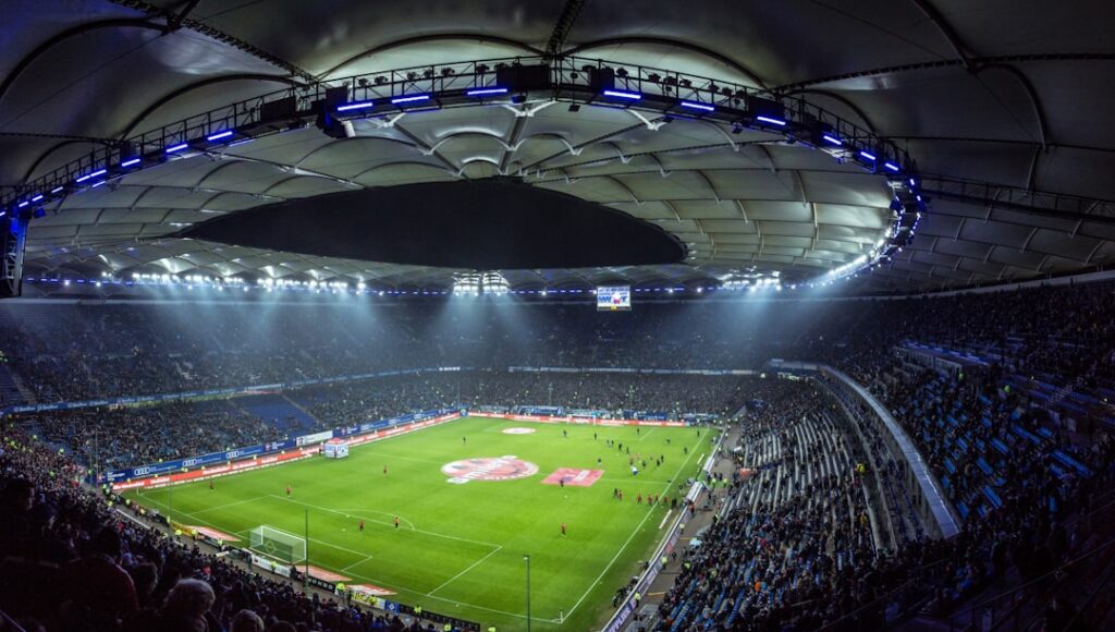 Fans waving flags fill the stands of Leipzig's stadium during a UEFA Euro 2024 match.