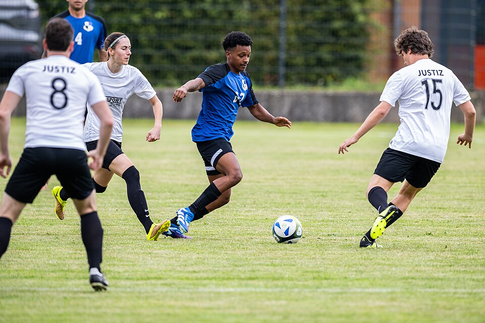 Soccer Players Competing In A Match